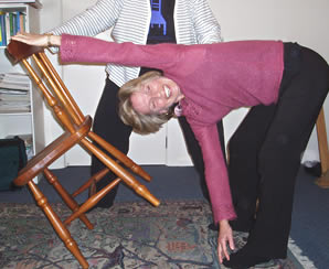 Using a chair to work on triangle pose.